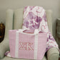 Purple gingham bag with Sigma Kappa Greek letters on a chair with a matching blanket.