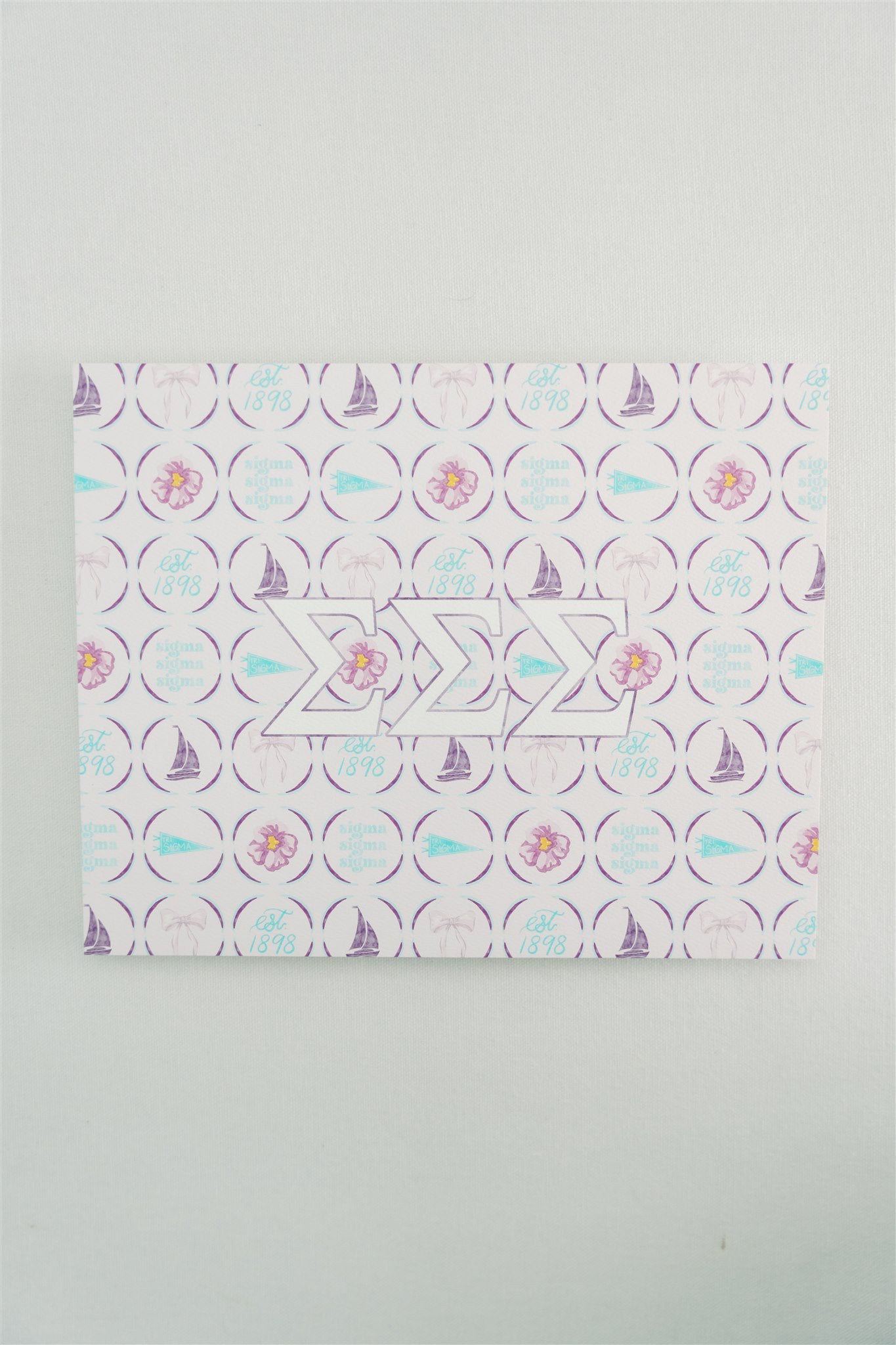 Decorative art print with geometric pattern and Tri Sigma Greek letters on a light gray background