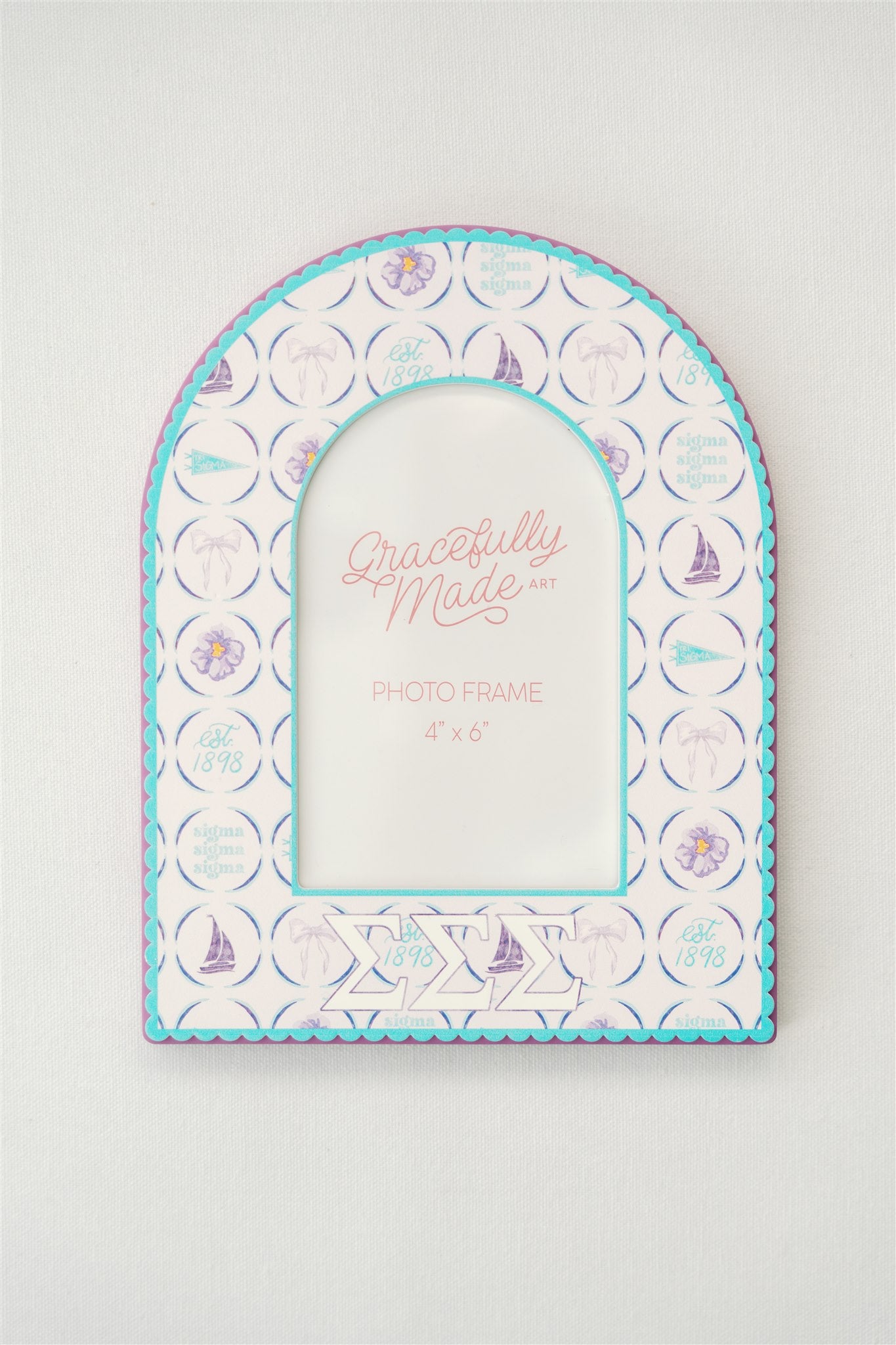 Arched photo frame with Sigma Sigma Sigma Greek letters and watercolor pattern on a white background.