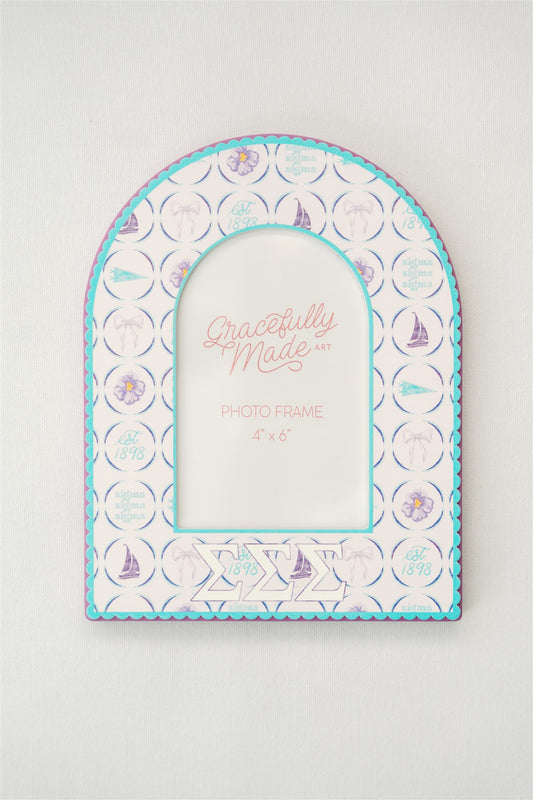 Arched photo frame with Sigma Sigma Sigma Greek letters and watercolor pattern on a white background.