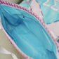 Close up of the Tri Sigma tote bag's bright blue interior liner and zipper pocket.