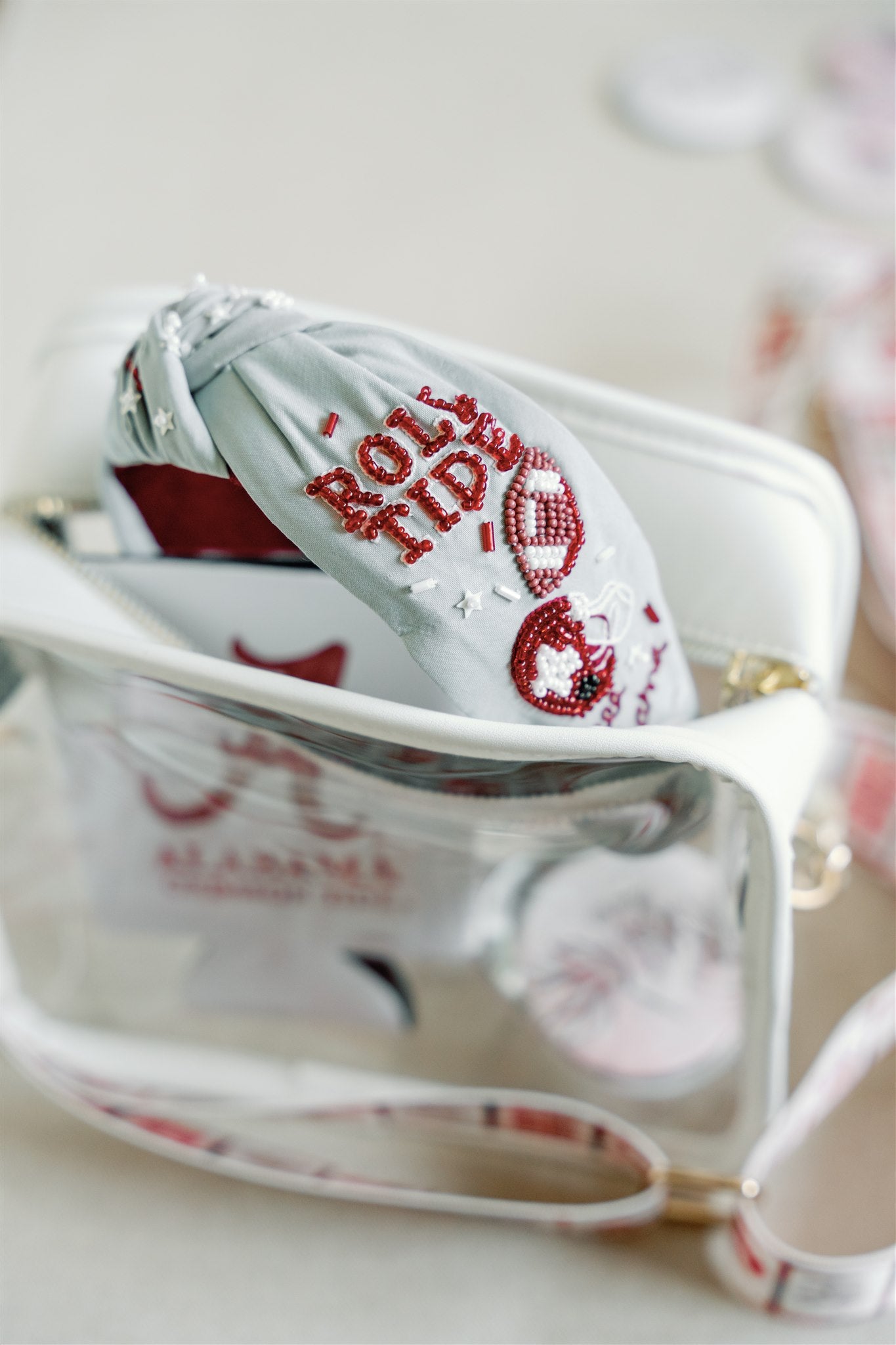 Light grey headband with red and white beaded University of Alabama symbols.