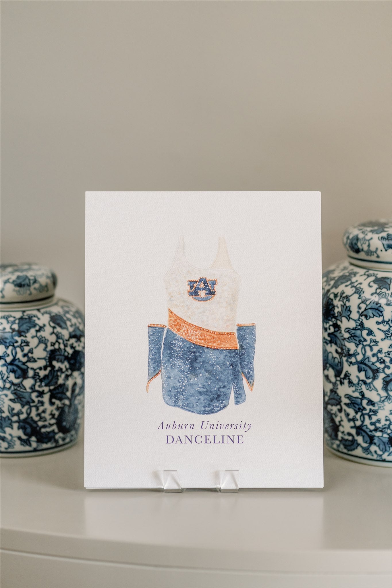 Watercolor art of the Auburn University Tiger Eyes Dance Uniform.