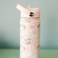 Light red water bottle with a University of Alabama pattern on a green surface and gray background
