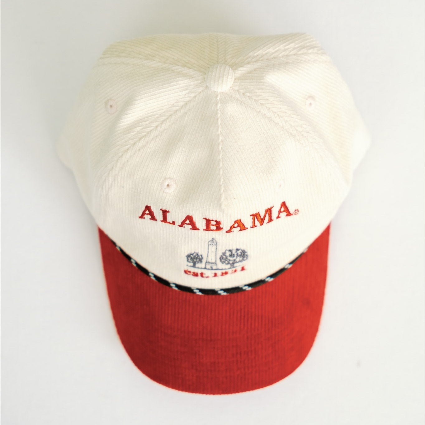 White and red baseball cap with 'Alabama' text on a white background