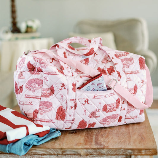 Light red quilted duffle bag with red University of Alabama symbols. 