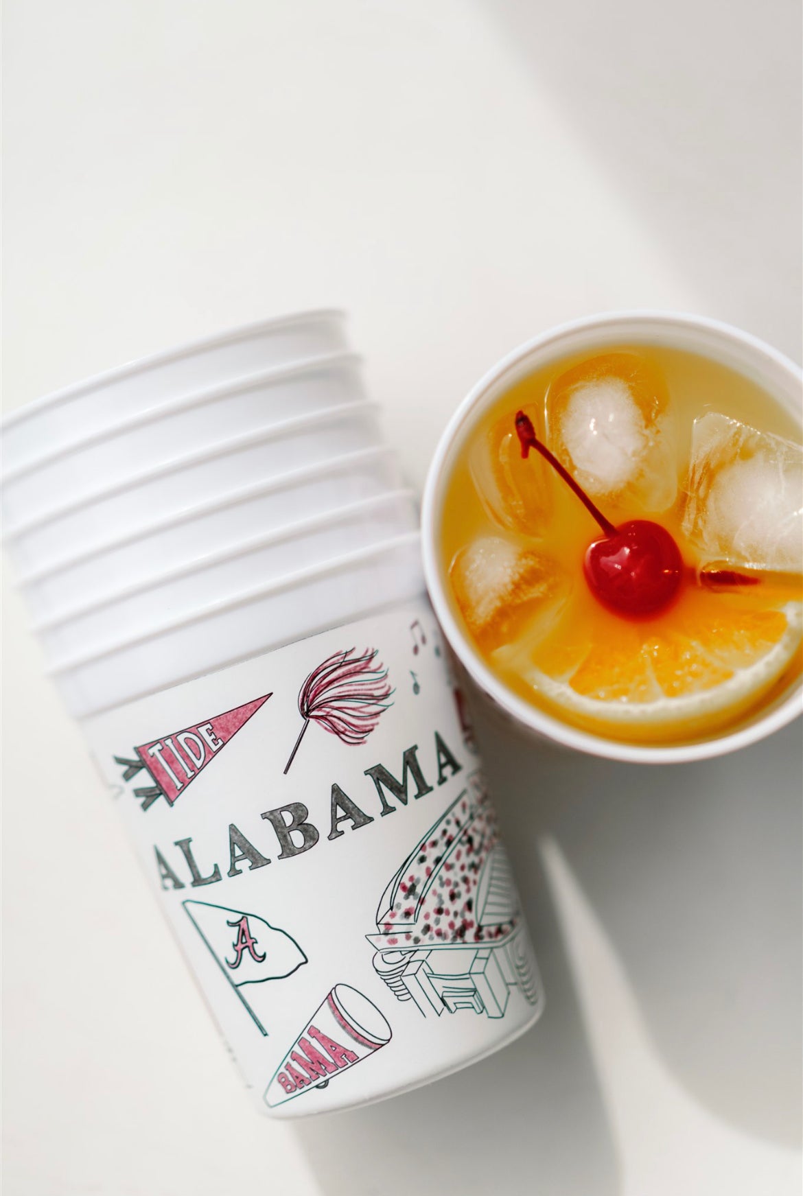 White plastic cups with University of Alabama symbols on them.