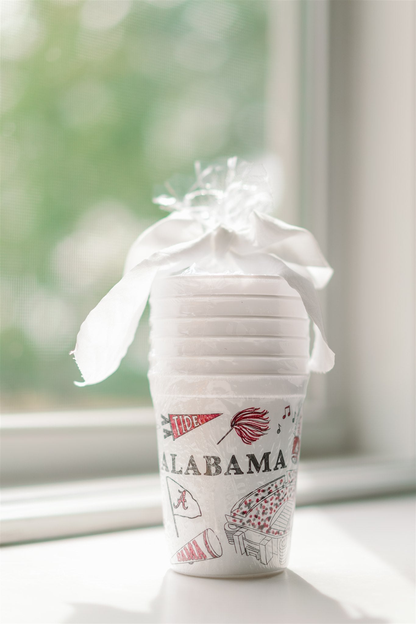 White plastic cups with University of Alabama symbols on them.