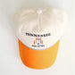 Baseball cap with 'Tennessee' text and orange brim on a white background
