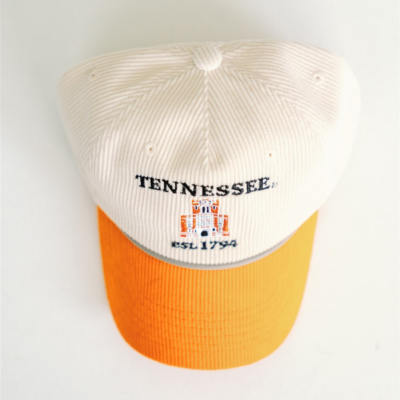 Baseball cap with 'Tennessee' text and orange brim on a white background