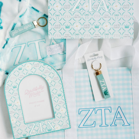 Zeta Tau Alpha (ZTA) themed merch items including an art print, a frame, and a bag on a white background.