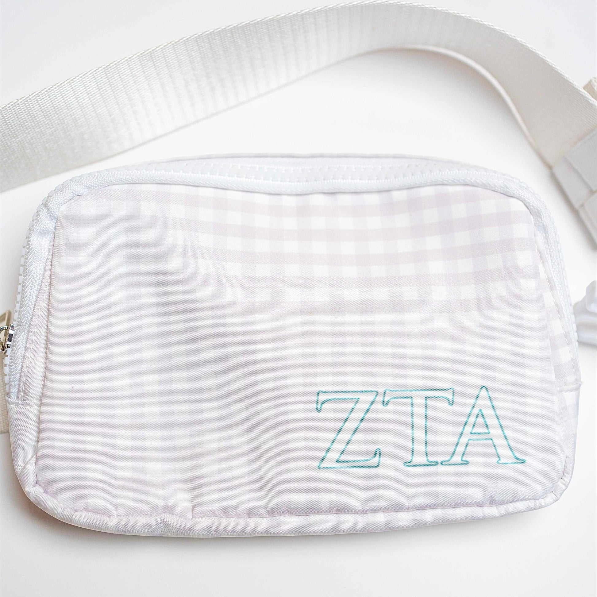 White gingham pouch with Zeta Tau Alpha Greek letters on a white background