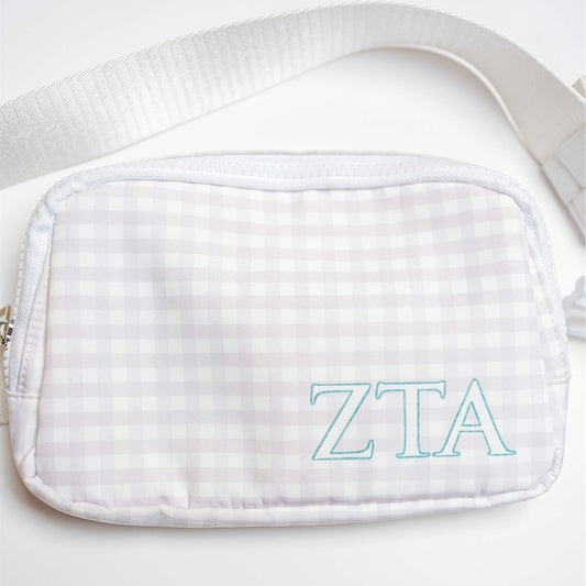 White gingham pouch with Zeta Tau Alpha Greek letters on a white background