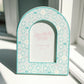 Decorative arch-shaped frame with 'Zeta Tau Alpha' Greek letters on a light background