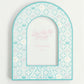 Decorative arch-shaped frame with Zeta Tau Alpha Greek letters and pattern on a white background