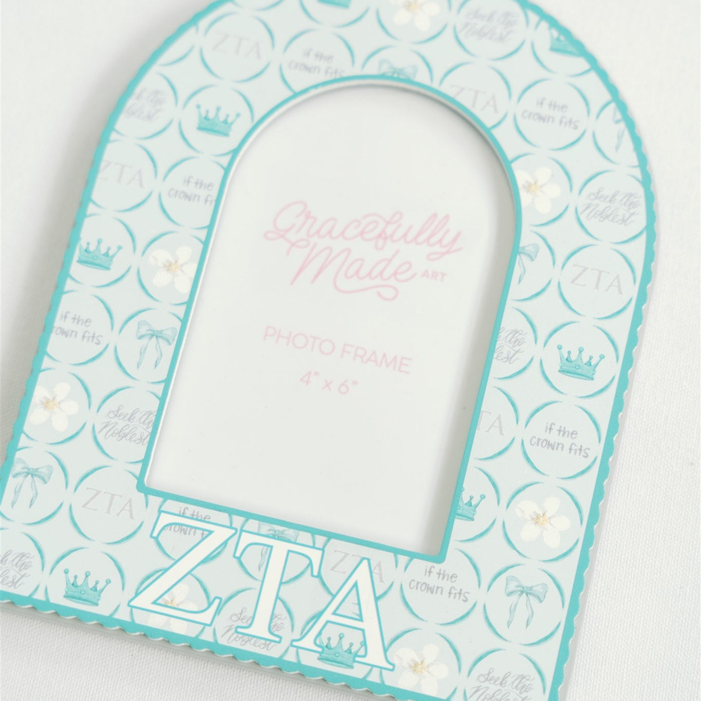 Teal and white decorative photo frame with Zeta Tau Alpha Greek letters on a white background