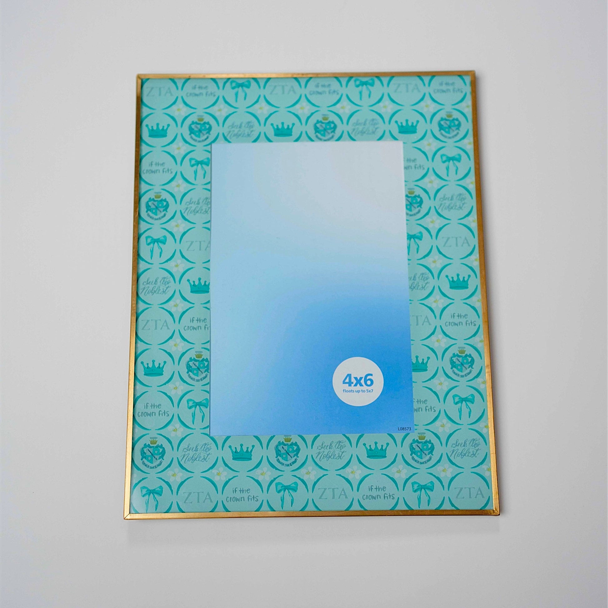 Teal Zeta Tau Alpha patterned frame with a gold metal edge.