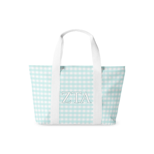 Tote bag with 'ZTA' Greek letters on a light blue and white checkered pattern