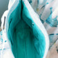 Close-up of the Zeta Tau Alpha tote bag teal interior lining and zipper pocket.